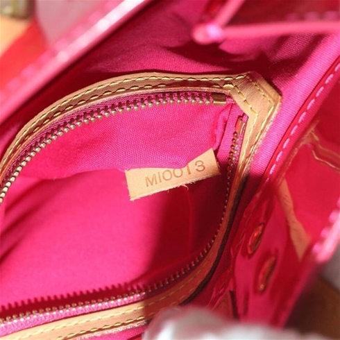 At Auction: A LOUIS VUITTON PINKY RED PATENT LEATHER ZIPPER BAG