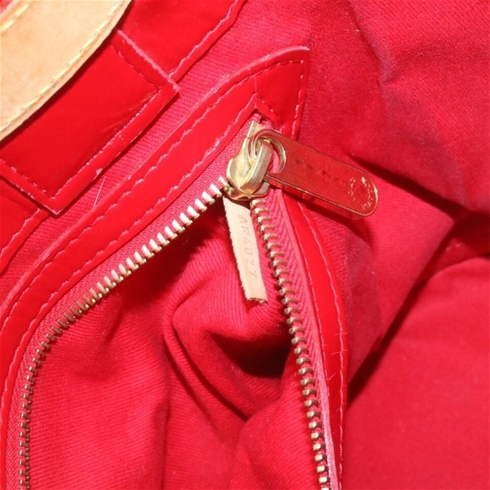 Sold at Auction: A LOUIS VUITTON RED PATENT LEATHER ZIPPER BAG