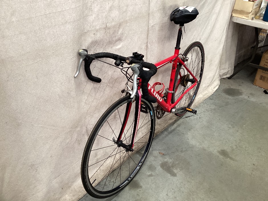 Red fluid road racing bike