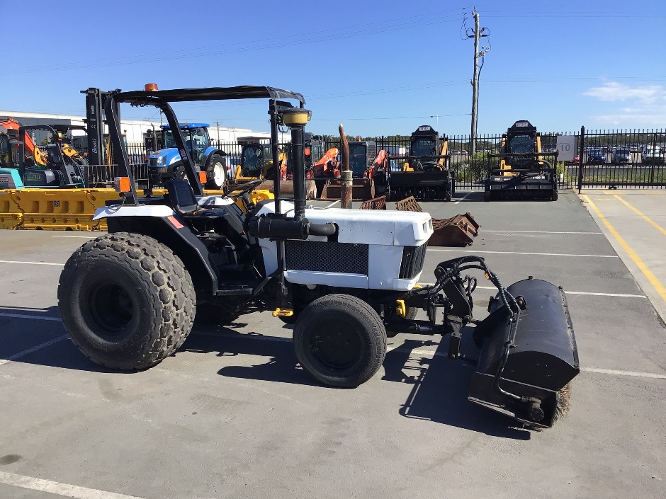 Tractor with Sweeper Attachment